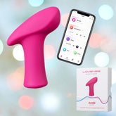 A Lovense Ambi Bluetooth-Controlled Bullet Vibrator in pink rests beside a smartphone displaying its intuitive control interface through the Lovense App. Below, a branded Lovense box highlights the features of the product. The background shimmers softly with circular lights.